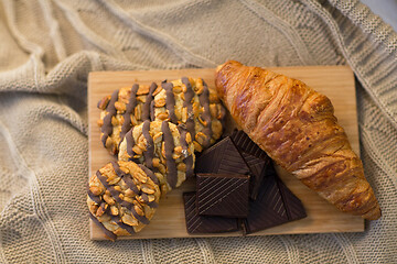 Image showing croissant, chocolate and cookies on wooden board