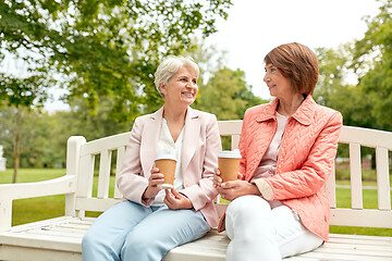 Image showing senior women or friends drinking coffee at park