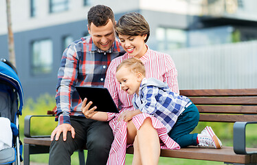 Image showing family with tablet pc sitting on bench in city