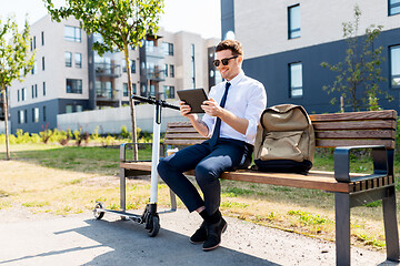 Image showing businessman with tablet computer, bag and scooter