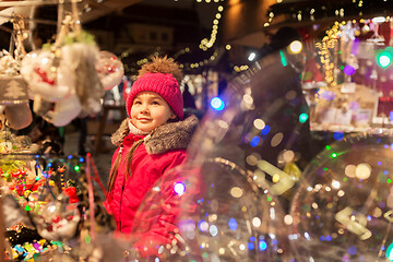 Image showing girl choosing christmas decorations at market