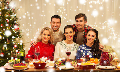 Image showing happy friends celebrating christmas at home