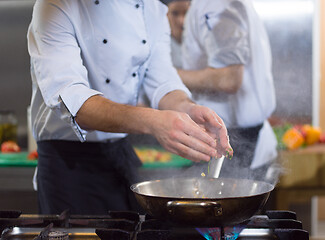 Image showing chef preparing food, frying in wok pan