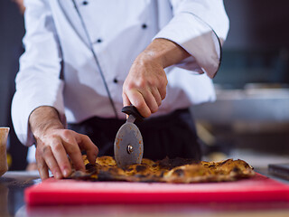 Image showing chef cutting baked bread