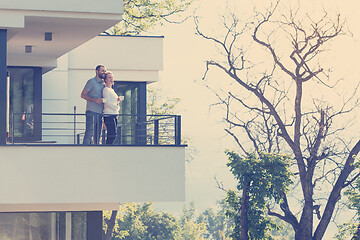 Image showing couple enjoying morning coffee on balcony