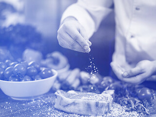 Image showing Chef putting salt on juicy slice of raw steak