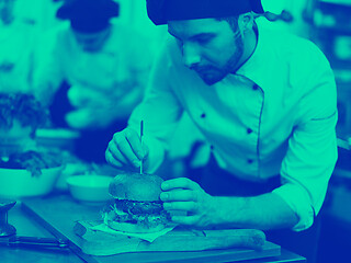 Image showing chef finishing burger