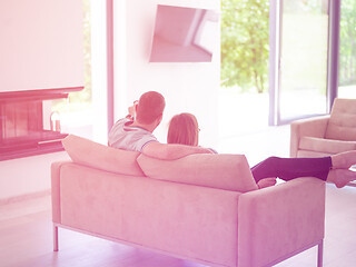 Image showing Young couple on the sofa watching television