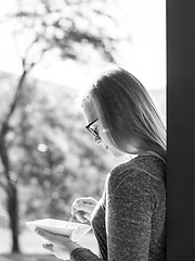 Image showing woman eating breakfast in front of her luxury home villa