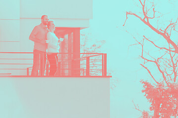 Image showing couple enjoying morning coffee on balcony