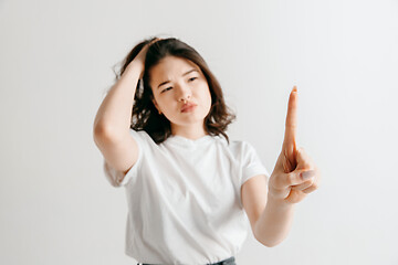 Image showing Woman\'s hand with finger on gray background