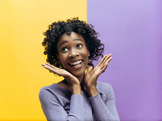 Image showing Winning success woman happy ecstatic celebrating being a winner. Dynamic energetic image of female afro model