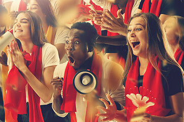 Image showing Group of happy fans are cheering for their team victory.