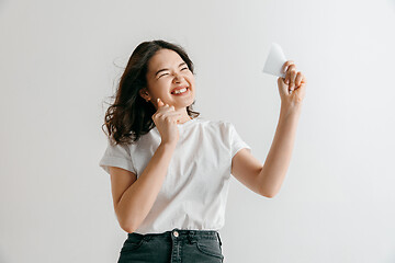 Image showing Young woman with a surprised expression won a bet