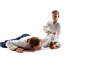 Image showing Man and teen boy fighting at aikido training in martial arts school