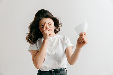 Image showing Young woman with a sad expression lost a bet