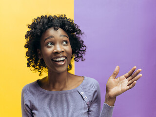 Image showing The happy african woman standing and smiling against gray background.