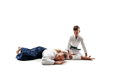 Image showing Man and teen boy fighting at aikido training in martial arts school