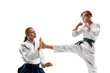 Image showing Man and teen boy fighting at aikido training in martial arts school