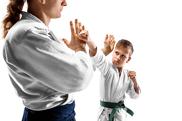 Image showing Man and teen boy fighting at aikido training in martial arts school