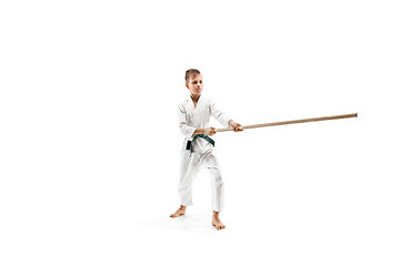 Image showing Teen boy fighting with wooden swords at Aikido training in martial arts school