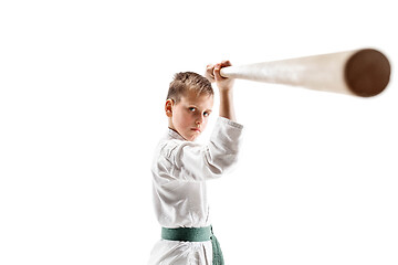 Image showing Teen boy fighting with wooden sword at Aikido training in martial arts school