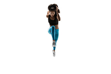 Image showing Young african woman running or jogging isolated on white studio background.