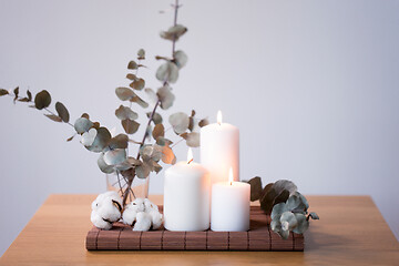 Image showing candles and branches of eucalyptus on table