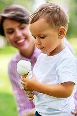 Image showing little boy eating ice cream with mother in summer