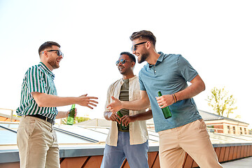 Image showing happy male friends with beer meeting on rooftop