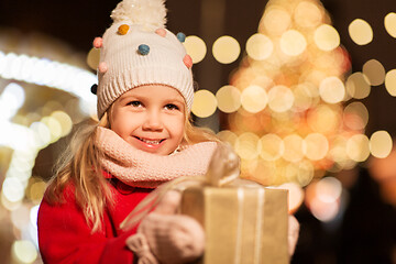 Image showing happy girl with gift box at christmas market