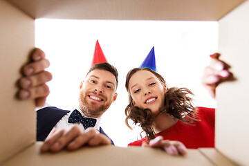 Image showing couple in party hats opening birthday gift box