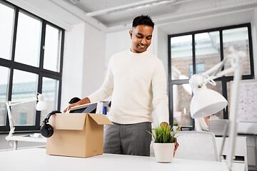 Image showing happy male office worker with personal stuff