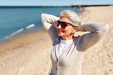 Image showing portrait of senior woman in sunglasses on beach