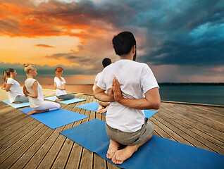 Image showing group of people making yoga exercises outdoors