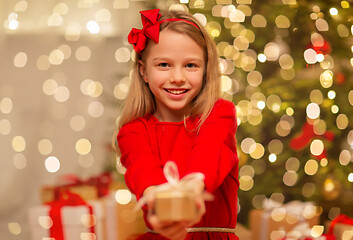 Image showing smiling girl with christmas gift at home