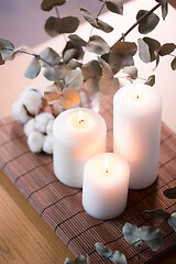 Image showing candles and branches of eucalyptus on table