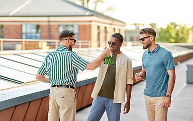 Image showing happy male friends drinking beer at rooftop party