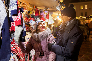 Image showing senior couple at christmas market clothing shop