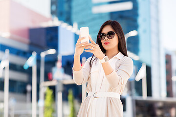 Image showing asian woman taking selfie by smartphone in city