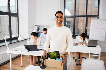 Image showing happy male office worker with personal stuff