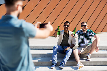 Image showing man photographing friends drinking beer on street