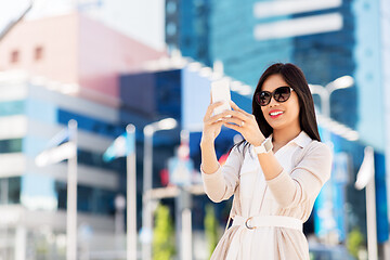 Image showing asian woman taking selfie by smartphone in city