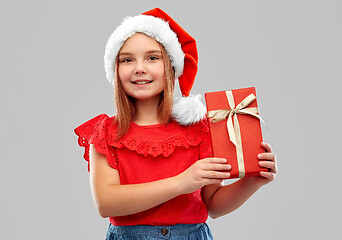 Image showing smiling girl in snata hat with christmas gift