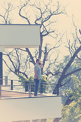 Image showing man drinking morning coffee on balcony