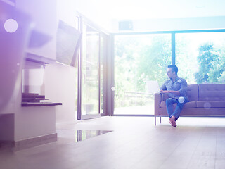 Image showing Man using laptop in living room