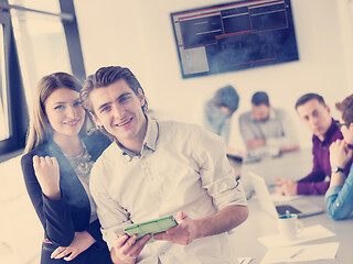 Image showing Two Business People Working With Tablet in office