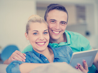 Image showing couple relaxing at  home with tablet computers