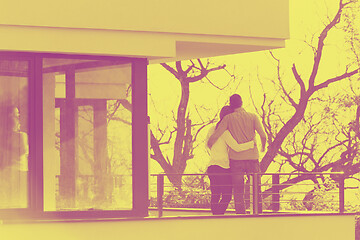 Image showing couple enjoying morning coffee on balcony