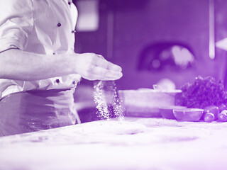 Image showing chef sprinkling flour over fresh pizza dough